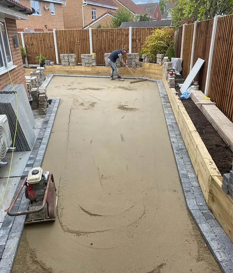 CSG Plastics & Build | Landscaping new Worker levelling wet concrete patio during installation