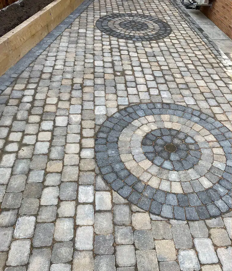 CSG Plastics & Build | Landscaping new Decorative paved driveway with circular spiral stone pattern