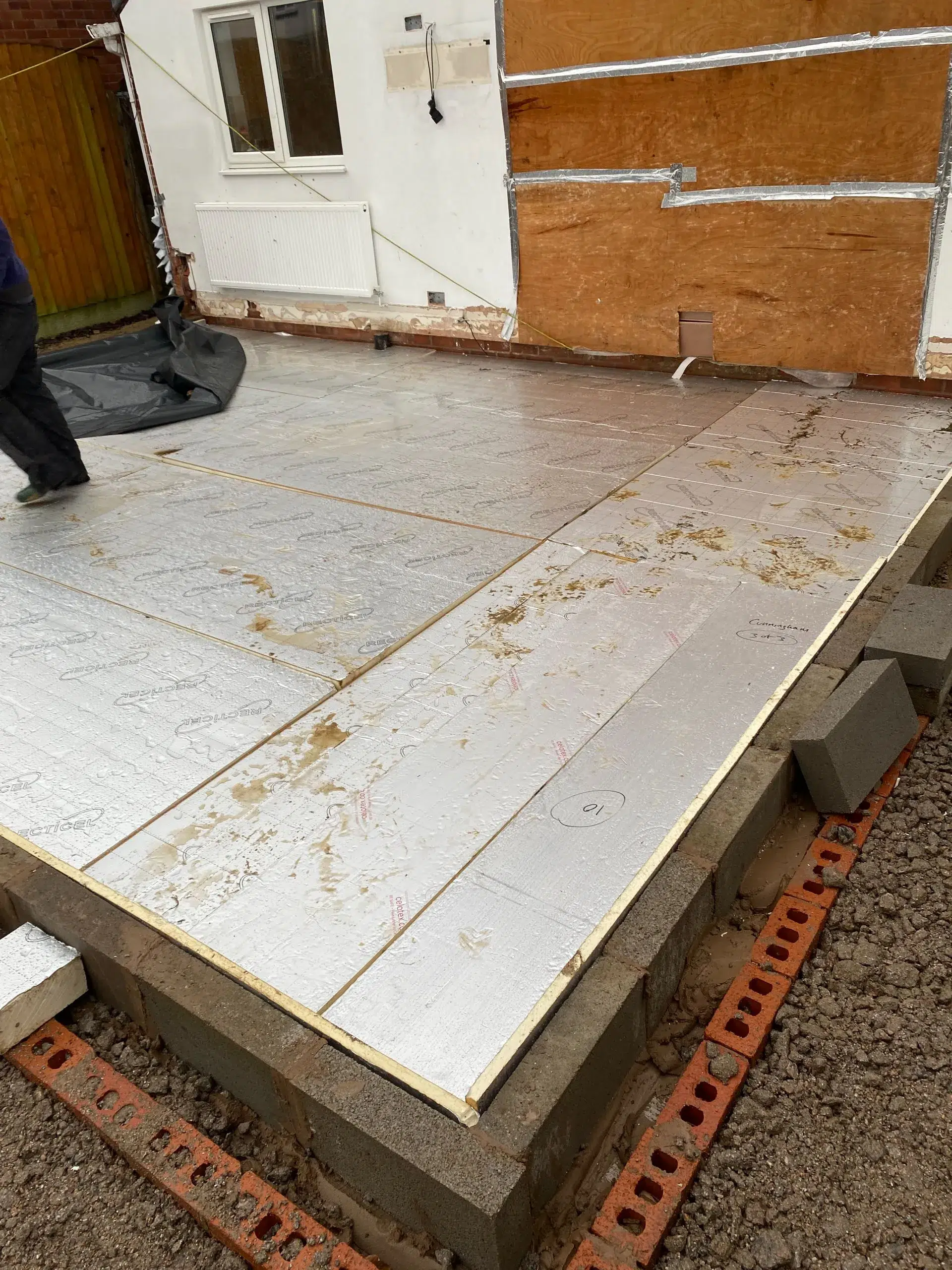 Construction site with insulation boards and concrete foundation