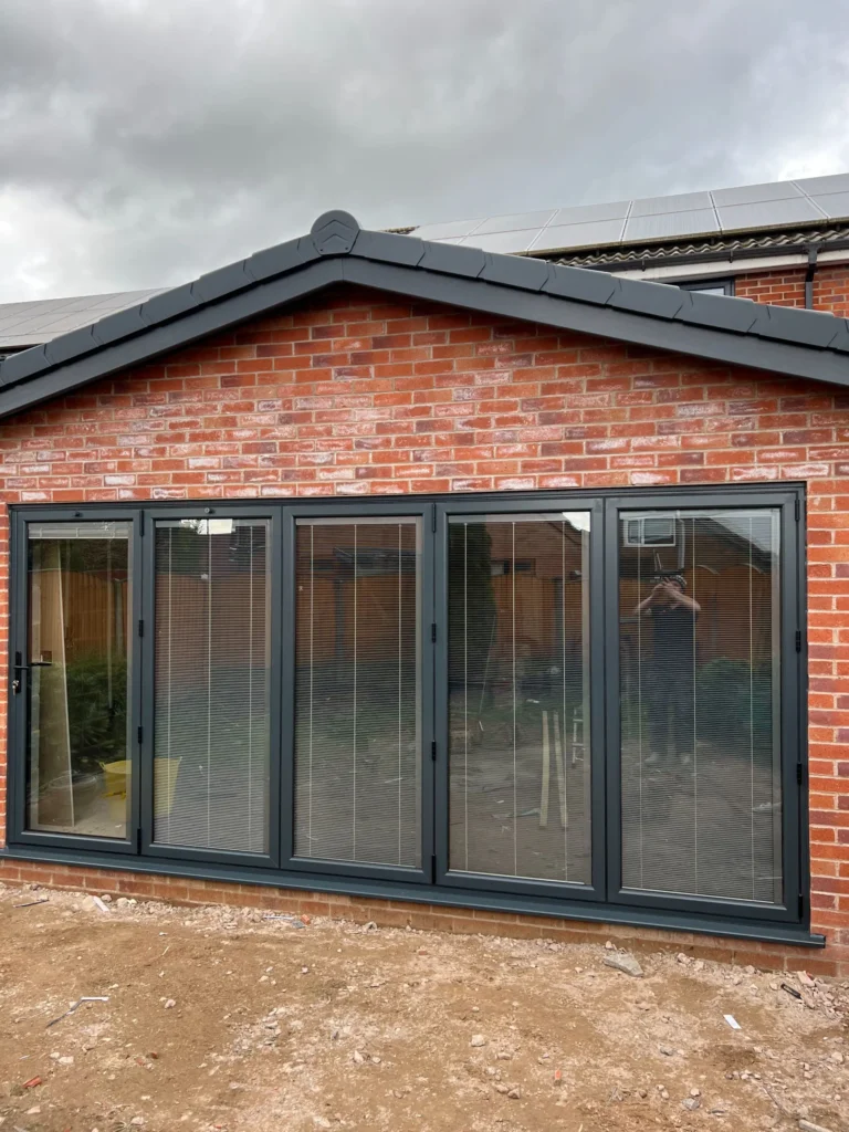 image00024 Modern black aluminium bi-fold doors on red brick house extension