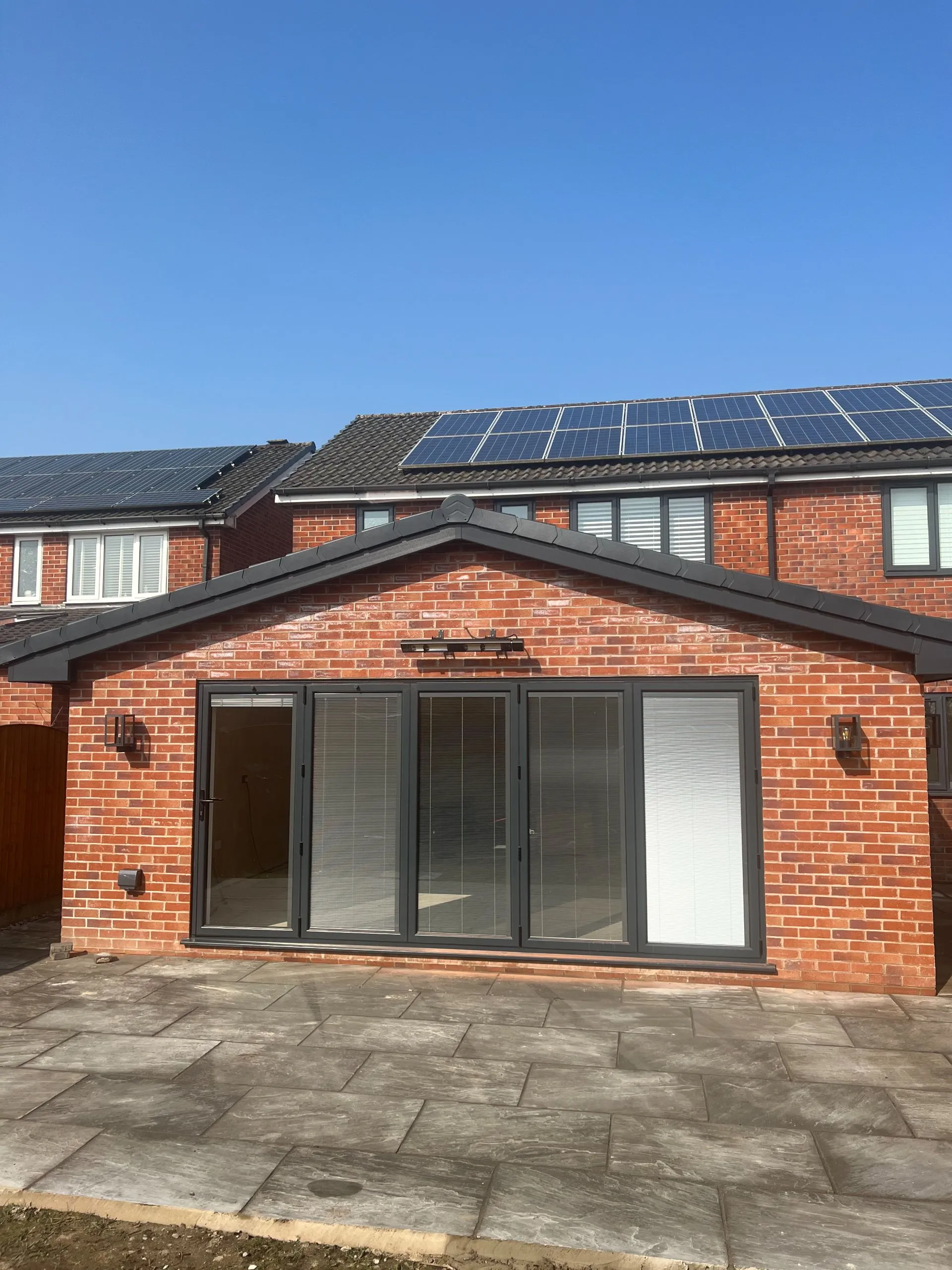 Modern brick extension with solar panels on roof
