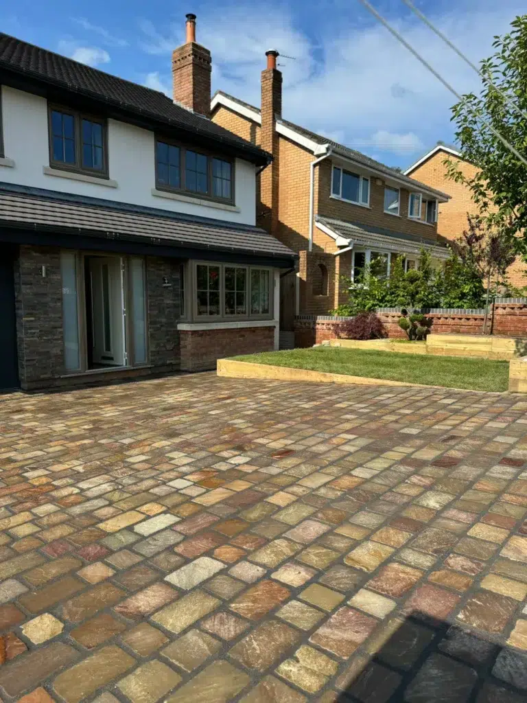 Modern brick houses with paved driveway and manicured garden