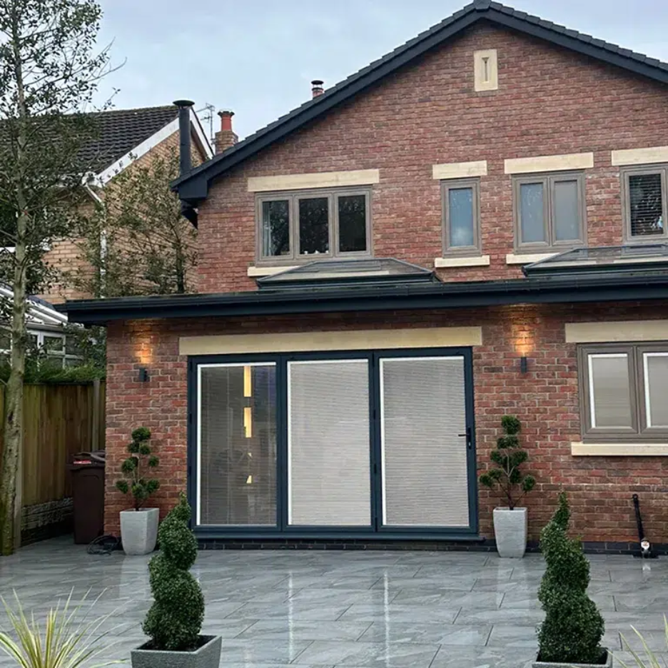 Modern brick house with black aluminium bi-fold doors